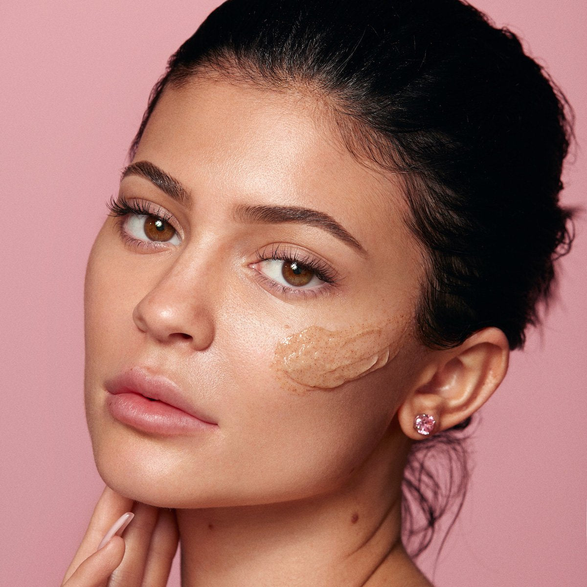 Kylie using Kylie Skin Walnut Face Scrub by Kylie Jenner